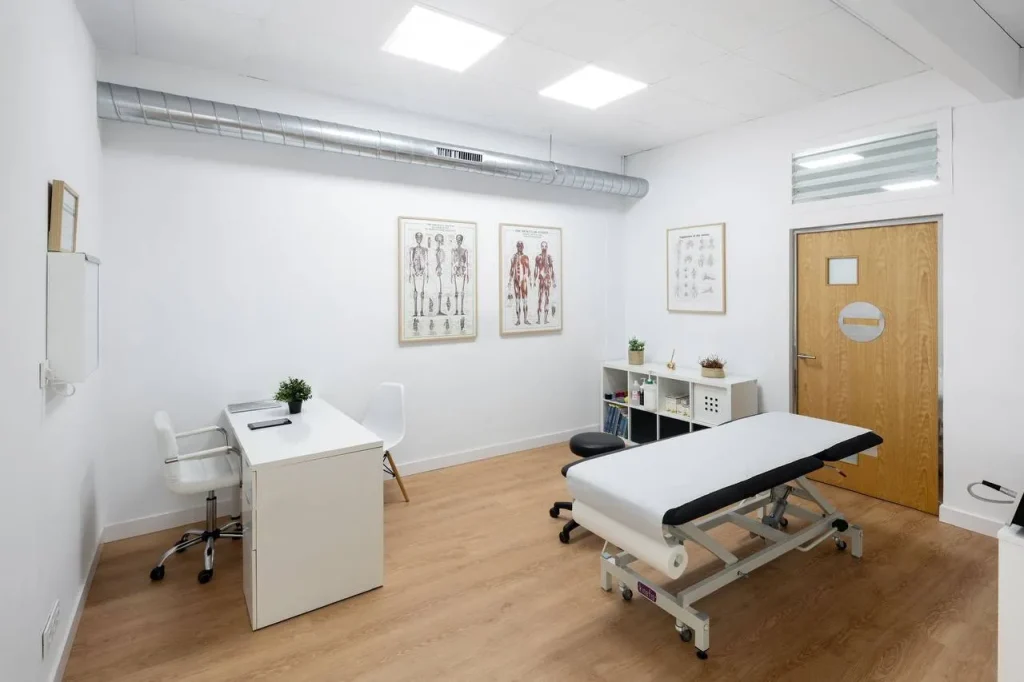 Sala de tratamiento de Asís Trincado Fisioterapia en Bilbao, equipada con camilla y material clínico.